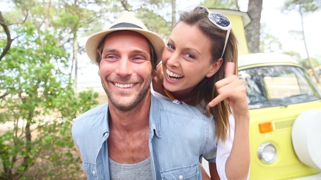 Cheerful couple of campers having fun on vacation