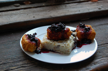 vegetarian dinner with breaded Camembert cheese, blueberry jam and rice