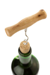 corkscrew and wine bottle on white