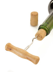 corkscrew and wine bottle on white