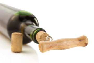 corkscrew and wine bottle on white