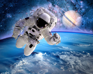 Astronaut spaceman outer space planet saturn earth universe. Elements of this image furnished by...