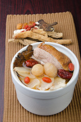 Chicken and herb soup in pot, Chinese food style.