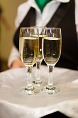 Three glasses of Champagne and a waiter
