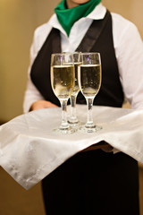 Three glasses of Champagne and a waiter