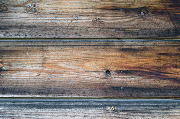 Old wooden wall with rusty nails, dark brown texture