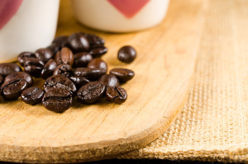 Two coffee cup on wooden board and coffee bottle with back backg