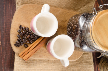 Two coffee cup on wooden board and coffee bottle with back backg