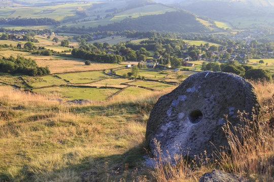 Millstone and golden fields above Curbar in summer, Curbar Edge, Peak District National Park, Derbyshire