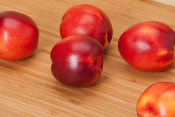 Fresh Nectarine Fruits On Wooden Board
