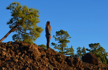 Woman / Girl on a mountain with blue sky.