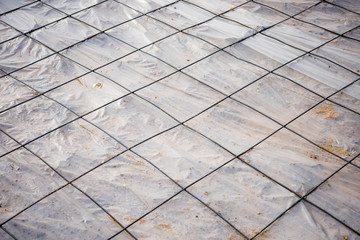 floor area covered in a sheet of plastic and a mesh of steel rei