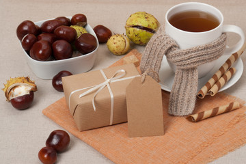 Gift Box With Blank Tag. Cup Of Hot Tea With Sweets. Chestnuts.