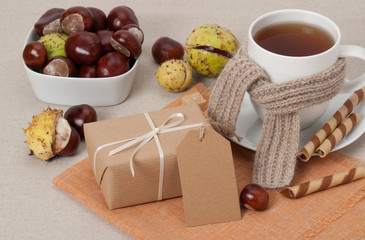 Gift Box With Blank Tag. Cup Of Hot Tea With Sweets. Chestnuts.