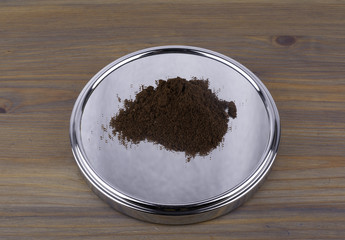 Ground coffee, mirror on the wooden table