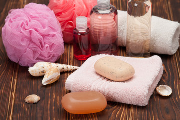 Fototapeta na wymiar Spa Kit. Shampoo, Soap, Body Lotion. Towels. Wooden Background