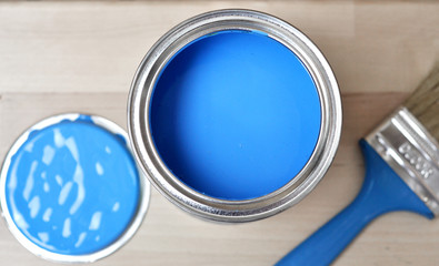 Full of blue paint tin and paint brush