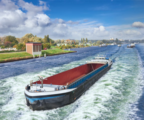 Naklejka premium Barge on the Amsterdam in summer day