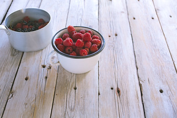 fresh raspberries and currant in the kitchen dish