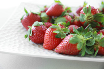 Fresh strawberries on white plate