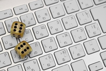 Gaming Dices  On The Computer Keyboard Close-up