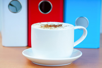 Coffee cup and office folders