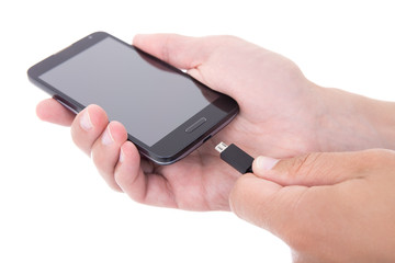 smart phone with blank screen and charger in hand isolated on wh