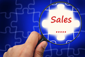 Sales word. Magnifier and puzzles.