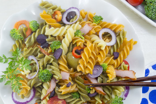 Pasta meal cooked with vegetables with fresh vegetables served w