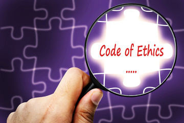 Code of Ethics word. Magnifier and puzzles.