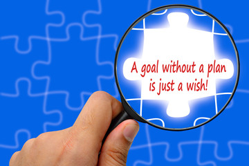 A goal without a plan is just a wish! word. Magnifier and puzzle