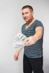 A man holds a U.S. $ 100, money