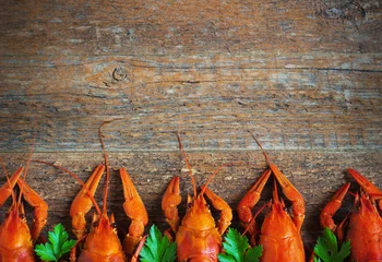 Foto auf Glas Boiled crayfish on a wooden background. © oksanka8306