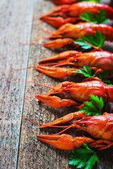 Boiled crayfish on a wooden background.