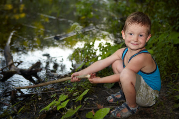 Little boy fishing in a river