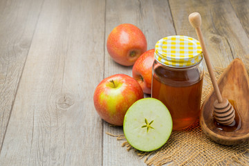 Apple and honey jar on wooden background. Jewish Rosh hashana (new year) celebration