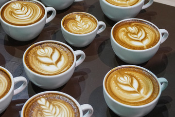 Many cup of  cappuccino coffee.