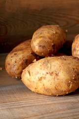 Potatoes.
Potatoes on a wooden surface.