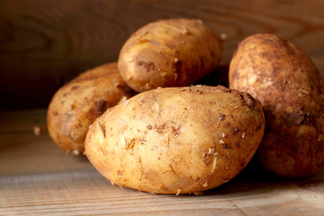 Potatoes.
Potatoes on a wooden surface.
