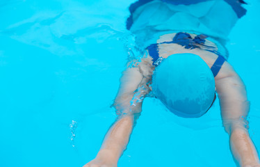 Woman relaxing on the swimming pool