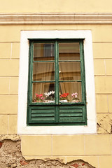 Fototapeta na wymiar Old wooden window with flowers