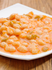 homemade stew of white beans on wood