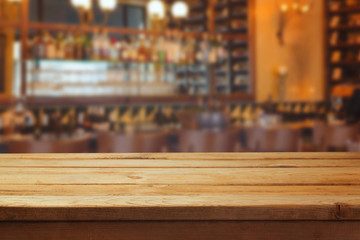 Blurred bar interior and wooden counter