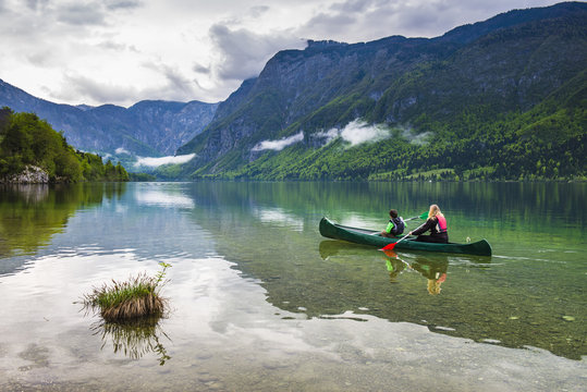 Mother and son canoeing on Lake Bohinj, Triglav National Park, Julian Alps, Slovenia
