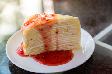Crepe cake with strawberry sauce