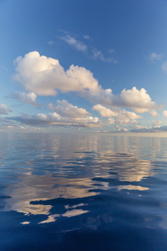 Reflected clouds in calm seas near the island of Deserta Grande, in the Ilhas Desertas, near Funchal, Madeira, Portugal, Atlantic