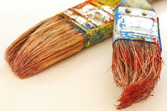 Two paint brushes on white background