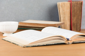 old book with pencil and coffee