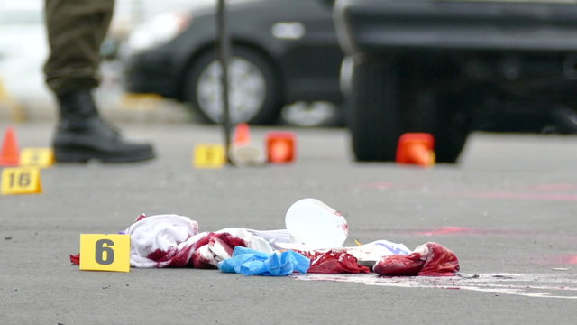 Bloodied clothes laying on the ground at crime scene