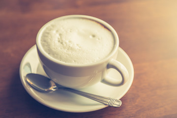 Hot latte art coffee on table ( Filtered image processed vintage